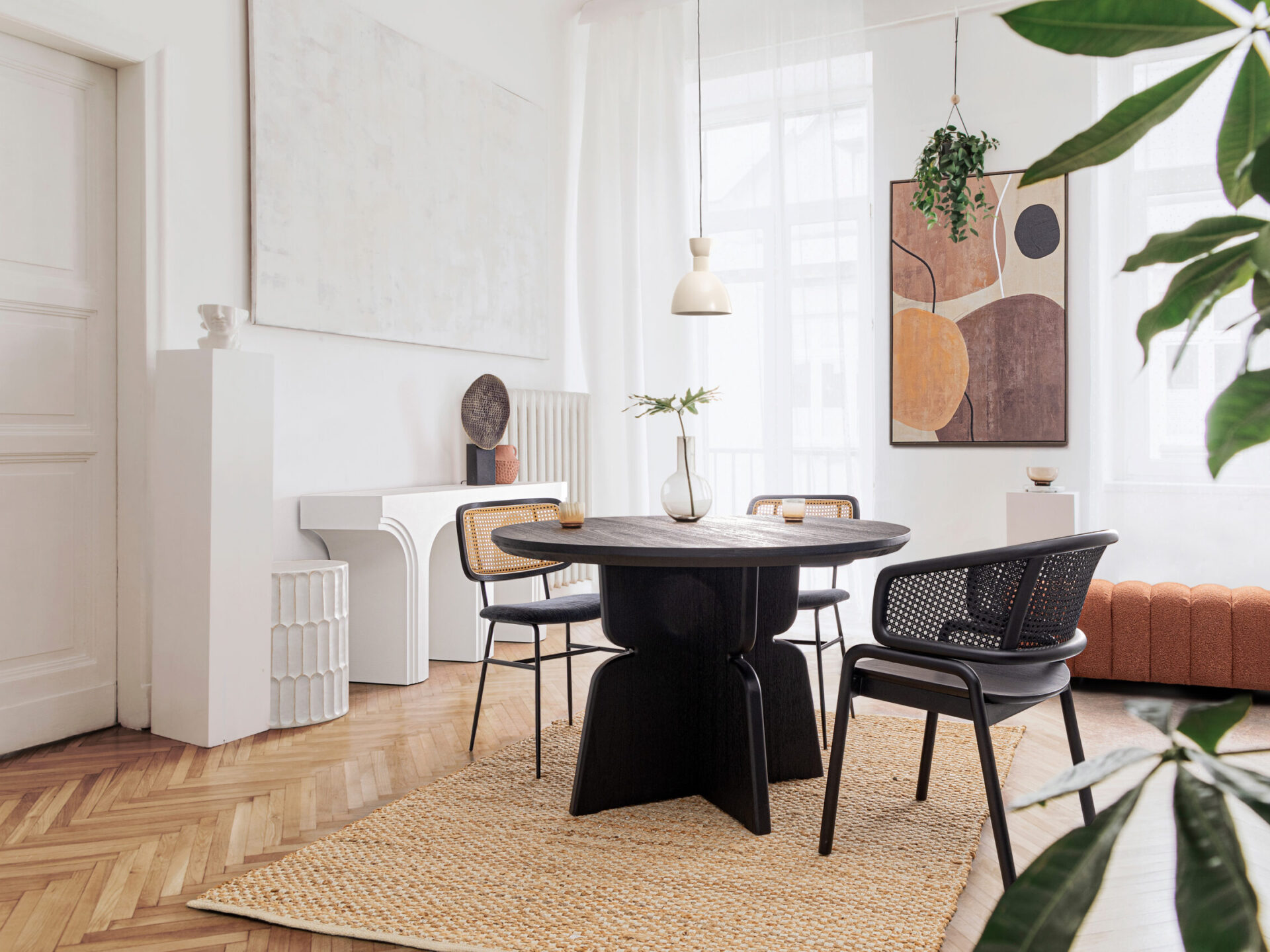 Stylish,And,Modern,Dining,Room,Interior,With,Design,Sharing,Table, Stylish and modern dining room interior with design sharing table, chairs, gold pendant lamp, abstract paintings and elegant accessories. Tropical leafs in vase. Eclectic home decor.
; Shutterstock ID 1922829779; purchase_order: -; job: -; client: -; other: -